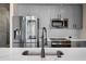 Modern kitchen features stainless steel appliances and sleek gray cabinetry at 155 S Court Ave # 1912, Orlando, FL 32801