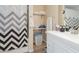 Clean bathroom with white vanity and chevron shower curtain at 2402 Sw 20Th Ter, Ocala, FL 34471