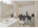 Bathroom with white vanity, shower, and city skyline curtain at 2402 Sw 20Th Ter, Ocala, FL 34471