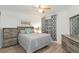 Guest bedroom with a grey bed and wood dresser at 2402 Sw 20Th Ter, Ocala, FL 34471