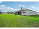 Large backyard with grassy area and screened porch at 2695 Hilltop Loop, Apopka, FL 32712