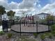 Community playground with modern equipment, enclosed in a black fence at 4778 Sparkling Shell Ave, Kissimmee, FL 34746