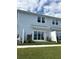 Private patio with sliding glass doors and small grassy area at 4778 Sparkling Shell Ave, Kissimmee, FL 34746