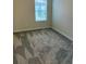 Bright bedroom with carpeted floor and window at 4778 Sparkling Shell Ave, Kissimmee, FL 34746
