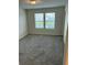 Bedroom with two windows offering natural light and lake view at 4778 Sparkling Shell Ave, Kissimmee, FL 34746