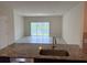 Living room with sliding glass doors leading to a patio and lake view at 4778 Sparkling Shell Ave, Kissimmee, FL 34746