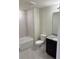 Clean bathroom with a bathtub, toilet and vanity with granite countertop at 4778 Sparkling Shell Ave, Kissimmee, FL 34746