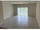 Spacious living room with tile flooring and access to a patio at 4778 Sparkling Shell Ave, Kissimmee, FL 34746
