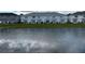 Tranquil pond reflects the sky and surrounding townhomes at 4778 Sparkling Shell Ave, Kissimmee, FL 34746