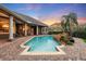 Inviting pool area with a rock waterfall feature and patio at 6102 S Hampshire Ct, Windermere, FL 34786