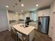 Modern kitchen featuring white cabinets, stainless steel appliances, and an island at 15121 Pigeon Plum Ln, Winter Garden, FL 34787