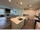 Open floor plan with kitchen island, living room with fireplace, and tile flooring at 15121 Pigeon Plum Ln, Winter Garden, FL 34787