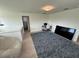 Spacious bonus room with a large TV, work area, and comfortable seating at 15121 Pigeon Plum Ln, Winter Garden, FL 34787