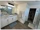 Elegant bathroom with double vanity, large mirror, and walk-in shower at 15121 Pigeon Plum Ln, Winter Garden, FL 34787