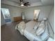Spacious main bedroom with large bed, ceiling fan, and walk-in closet at 15121 Pigeon Plum Ln, Winter Garden, FL 34787