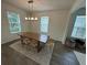 Bright dining room featuring a wood table and six chairs at 15121 Pigeon Plum Ln, Winter Garden, FL 34787