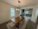 Formal dining room with wood table and modern chandelier at 15121 Pigeon Plum Ln, Winter Garden, FL 34787