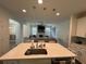 Open concept kitchen and living area with kitchen island and a fireplace at 15121 Pigeon Plum Ln, Winter Garden, FL 34787