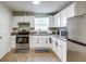 Modern kitchen with stainless steel appliances and white cabinets at 280 Westwood Ave, Winter Haven, FL 33880