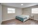 Bright bedroom with a king-size bed and teal blanket at 280 Westwood Ave, Winter Haven, FL 33880