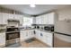 Modern kitchen with stainless steel appliances and white cabinets at 280 Westwood Ave, Winter Haven, FL 33880