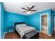 Bedroom with light blue walls, ceiling fan and wood floors at 3390 Cedar Spring Pl # 163, Winter Park, FL 32792