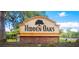 Hidden Oaks community entrance sign with stone base and oak tree logo at 3390 Cedar Spring Pl # 163, Winter Park, FL 32792