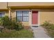 Inviting condo entrance with red door, landscaping, and walkway at 3390 Cedar Spring Pl # 163, Winter Park, FL 32792