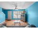 Living room with blue walls, gray couch, and view of entryway at 3390 Cedar Spring Pl # 163, Winter Park, FL 32792