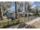 Blue house with a black fence and mature trees at 4963 Neponset Ave, Orlando, FL 32808