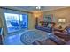Living room with sliding doors to balcony, comfortable seating and ocean view at 5300 S Atlantic Ave # 2-502, New Smyrna Beach, FL 32169