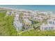 Aerial view of condo community near beach, featuring multiple buildings and lush landscaping at 5300 S Atlantic Ave # 2-502, New Smyrna Beach, FL 32169