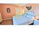 King-size bed, light peach walls, and coastal decor in the main bedroom at 5300 S Atlantic Ave # 2-502, New Smyrna Beach, FL 32169