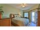 Bedroom with light green walls, queen bed, and access to balcony at 5300 S Atlantic Ave # 2-502, New Smyrna Beach, FL 32169