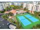 Aerial view showing tennis courts, shuffleboard, and pool area at 5300 S Atlantic Ave # 2-502, New Smyrna Beach, FL 32169