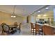 Dining area with kitchen access, breakfast bar, and modern light fixture at 5300 S Atlantic Ave # 2-502, New Smyrna Beach, FL 32169