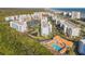 Aerial view of condo community with pool, tennis courts, and ocean views at 5300 S Atlantic Ave # 2-502, New Smyrna Beach, FL 32169