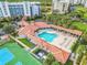 Relaxing community pool area with surrounding lounge chairs and adjacent tennis courts at 5300 S Atlantic Ave # 2-502, New Smyrna Beach, FL 32169