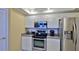 Galley kitchen with stainless steel appliances and granite countertops at 5300 S Atlantic Ave # 2-502, New Smyrna Beach, FL 32169
