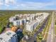 Aerial view of condo community near beach, featuring multiple buildings and lush landscaping at 5300 S Atlantic Ave # 2-502, New Smyrna Beach, FL 32169