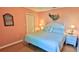 King-size bed, light peach walls, and coastal decor in the main bedroom at 5300 S Atlantic Ave # 2-502, New Smyrna Beach, FL 32169