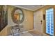 Bright entryway with glass block window, console table, and mirror at 5300 S Atlantic Ave # 2-502, New Smyrna Beach, FL 32169