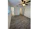 Bedroom with ceiling fan, vinyl flooring, and en-suite bathroom at 603 Maggie Cir, Winter Haven, FL 33880