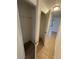 Bright hallway with tile flooring and access to closets at 603 Maggie Cir, Winter Haven, FL 33880