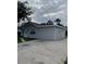 Another view of the house showing a detached structure at 603 Maggie Cir, Winter Haven, FL 33880