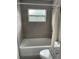 Clean bathroom with tub shower combination and gray tile at 603 Maggie Cir, Winter Haven, FL 33880