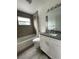 Updated bathroom with granite countertop and gray tile at 603 Maggie Cir, Winter Haven, FL 33880