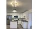 Modern kitchen with white cabinets, stainless steel appliances, and an island at 603 Maggie Cir, Winter Haven, FL 33880