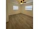 Bright and airy bedroom with new flooring and ceiling fan at 603 Maggie Cir, Winter Haven, FL 33880