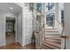 Impressive curved staircase with wood railing and a view to the living room at 8407 River Branch Pl, Sanford, FL 32771